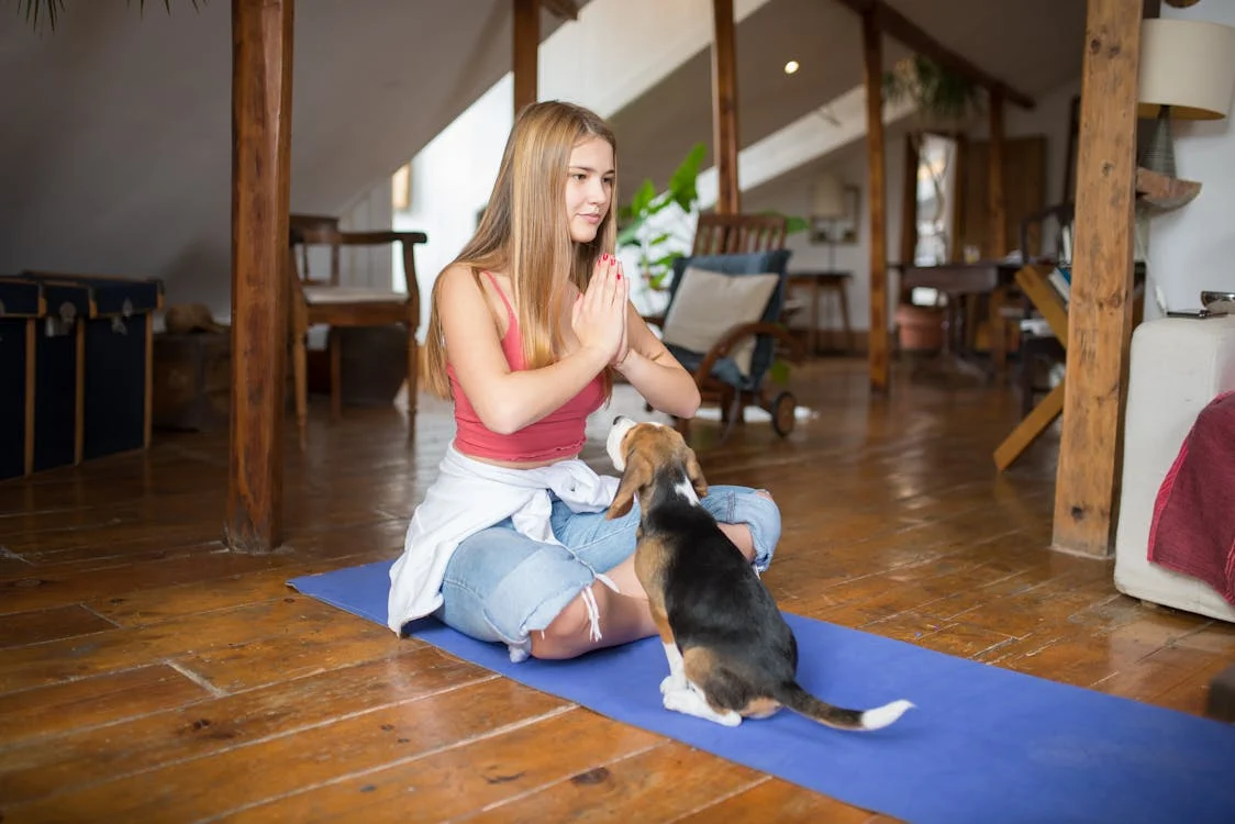 Dog Sitting in Front of a Woman, puppy yoga // Healthier Pets Today