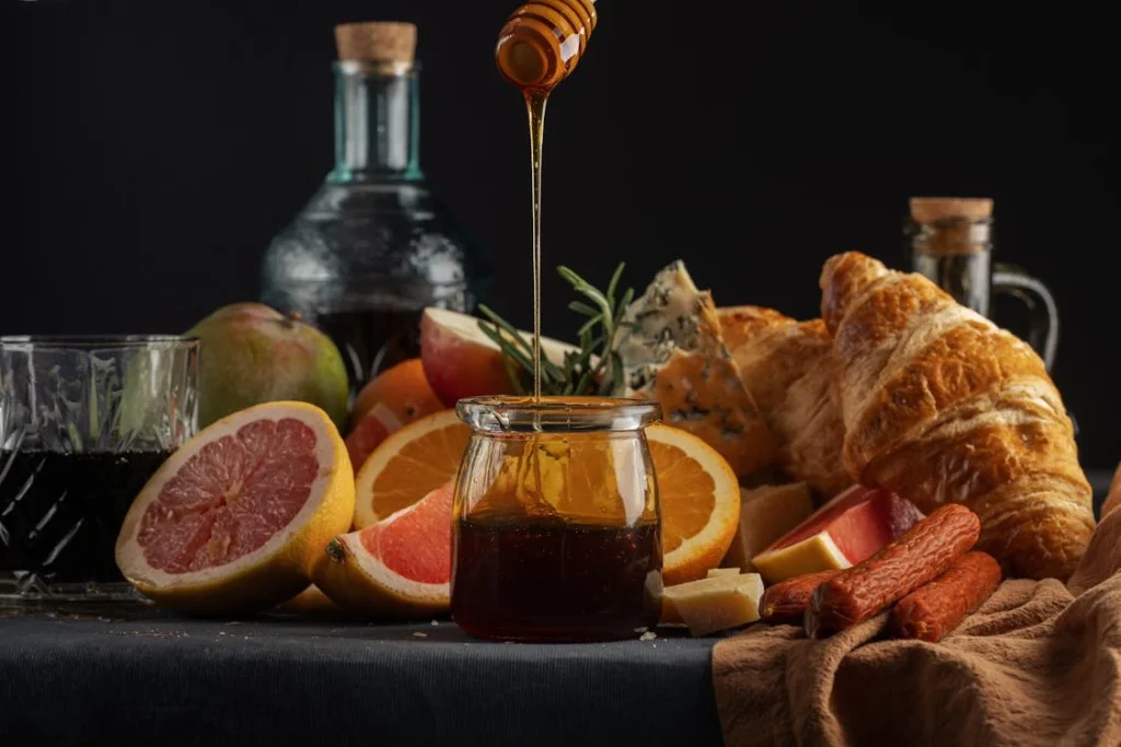 Sliced Orange Fruit Beside Clear Glass Jar with Honey // Healthier Pets Today