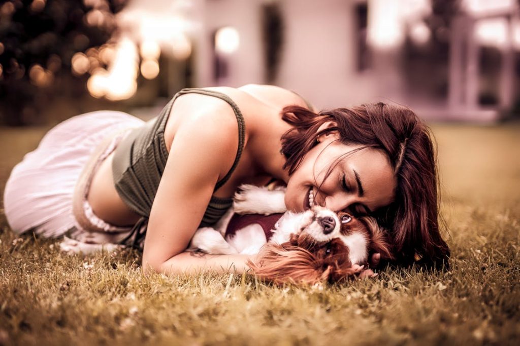 Woman in Tank Top Playing with her Dog // Healthier Pets Today